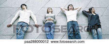 Young people, reclining side by side View Large Photo Image Stock Image - Young people, reclining side by side. Fotosearch