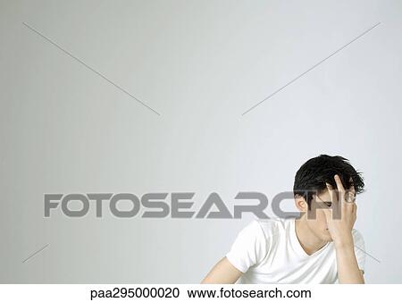 Young man covering face with hand View Large Photo Image Stock Image - Young man covering face with hand. Fotosearch