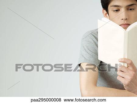 Young man reading book, portrait View Large Photo Image Stock Photo - Young man reading book, portrait. Fotosearch