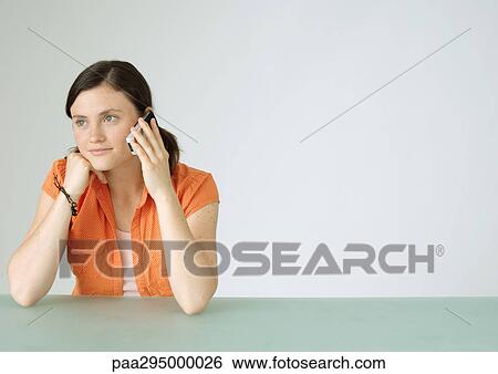 Young woman using cell phone View Large Photo Image Stock Photograph - Young woman using cell phone. Fotosearch
