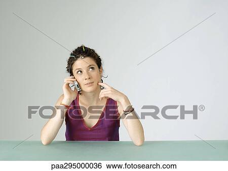 Young woman using cell phone View Large Photo Image Stock Photograph - Young woman using cell phone. Fotosearch