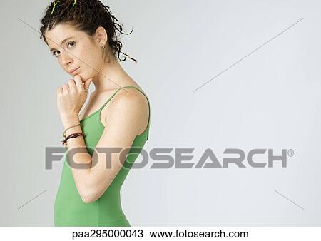 Young woman with hand under chin, portrait View Large Photo Image Stock Image - Young woman with hand under chin, portrait. Fotosearch