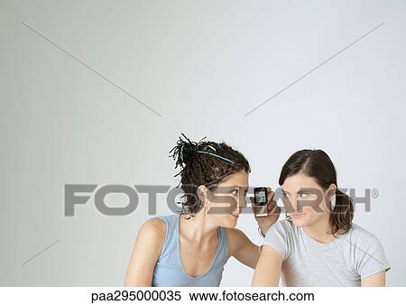 Young women with camera phone, portrait View Large Photo Image Stock Photography - Young women with camera phone, portrait. Fotosearch