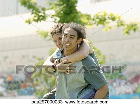 Man carrying young woman piggyback View Large Photo Image Stock Image - Man carrying young woman piggyback. Fotosearch