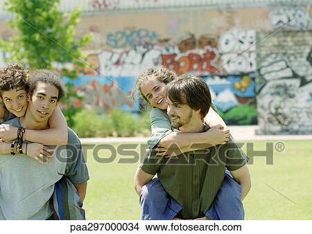 Men carrying young women piggyback View Large Photo Image Picture - Men carrying young women piggyback. Fotosearch