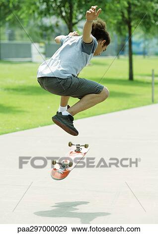 Skateboarder in mid-air View Large Photo Image Stock Photo - Skateboarder in mid-air. Fotosearch