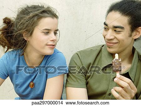 Young couple eating ice cream View Large Photo Image Picture - Young couple eating ice cream. Fotosearch