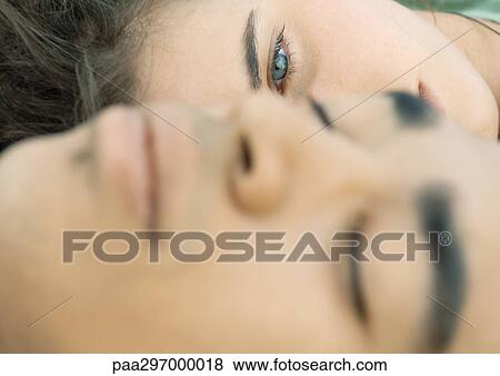 Young couple's faces, close-up View Large Photo Image Stock Photo - Young couple's faces, close-up. Fotosearch