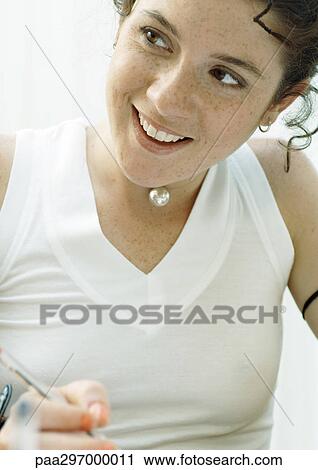 Young woman smiling, portrait View Large Photo Image Stock Image - Young woman smiling, portrait. Fotosearch