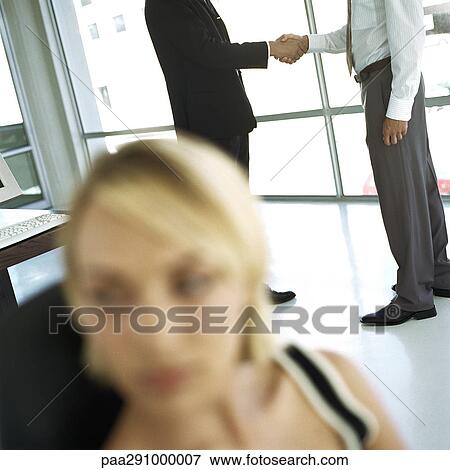 Businessmen shaking hands in office View Large Photo Image Stock Photo - Businessmen shaking hands in office. Fotosearch