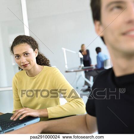 Picture - Casually dressed people working in office. Fotosearch