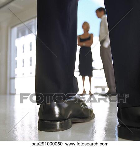 Well-dressed man's legs, man and woman standing near window View Large Photo Image Stock Image - Well-dressed man's legs, man and woman standing near window. Fotosearch