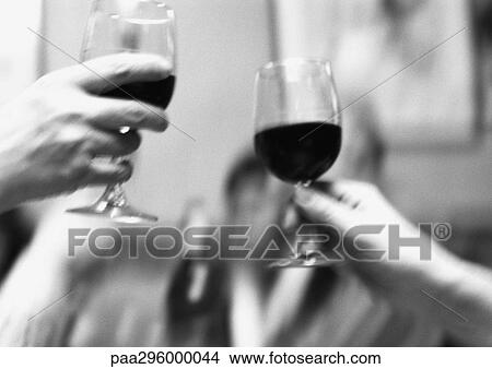 Picture - Hands holding up glasses of wine . Fotosearch