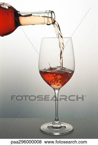 Stock Photo - Pouring a glass of rosÄ wine. Fotosearch