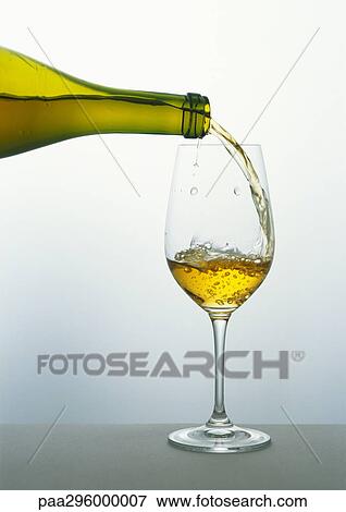 Stock Photo - Pouring a glass of white wine. Fotosearch