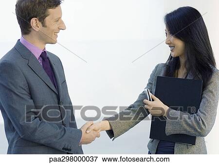 Businessman and businesswoman shaking hands View Large Photo Image Stock Photo - Businessman and businesswoman shaking hands. Fotosearch
