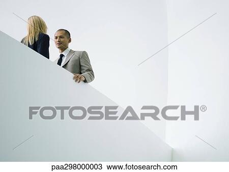 Businessman and businesswoman standing face to face, low angle view View Large Photo Image Stock Image - Businessman and businesswoman standing face to face, low angle view. Fotosearch