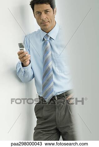 Businessman holding cell phone View Large Photo Image Stock Image - Businessman holding cell phone. Fotosearch