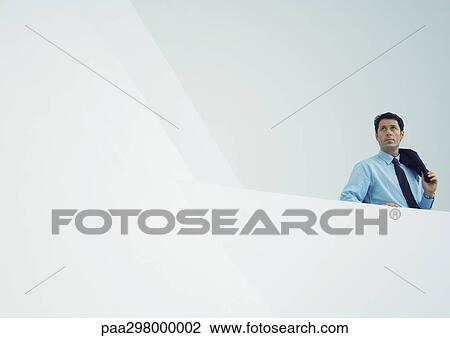 Businessman holding jacket over shoulder View Large Photo Image Stock Image - Businessman holding jacket over shoulder. Fotosearch