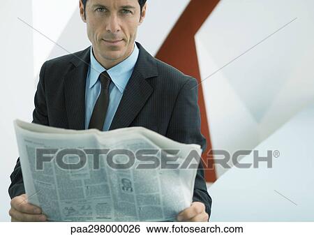 Businessman holding newspaper View Large Photo Image Stock Photograph - Businessman holding newspaper. Fotosearch
