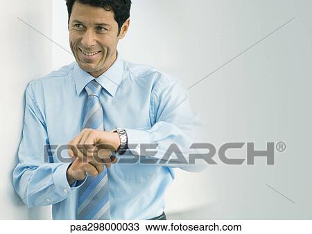 Businessman pointing to watch View Large Photo Image Stock Image - Businessman pointing to watch. Fotosearch