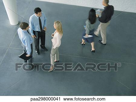 Businesspeople in lobby, high angle view View Large Photo Image Stock Image - Businesspeople in lobby, high angle view. Fotosearch