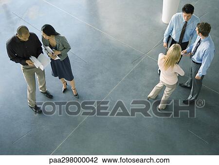Businesspeople in lobby, high angle view View Large Photo Image Stock Image - Businesspeople in lobby, high angle view. Fotosearch