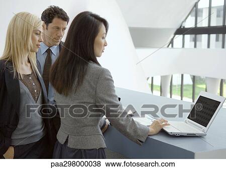 Three businesspeople using laptop View Large Photo Image Stock Photo - Three businesspeople using laptop. Fotosearch