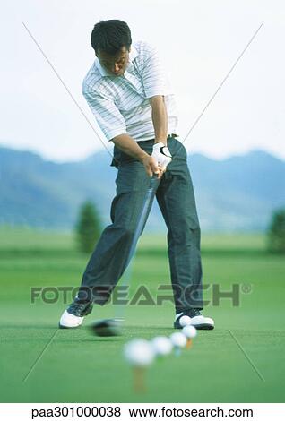 Golfer practicing on driving range View Large Photo Image Stock Photo - Golfer practicing on driving range. Fotosearch