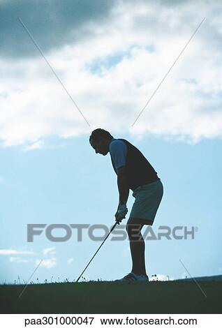Golfer preparing to swing, backlit View Large Photo Image Stock Photo - Golfer preparing to swing, backlit. Fotosearch