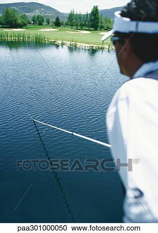 Golfer retrieving ball in pond with pole View Large Photo Image Stock Image - Golfer retrieving ball in pond with pole. Fotosearch