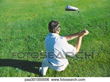 Golfer swinging, high angle view View Large Photo Image Stock Photograph - Golfer swinging, high angle view. Fotosearch