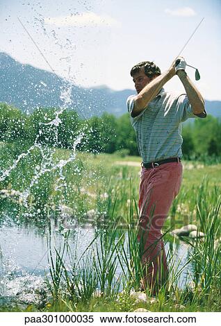 Golfer swinging in water View Large Photo Image Stock Photography - Golfer swinging in water. Fotosearch