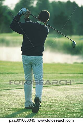 Golfer swinging View Large Photo Image Stock Photography - Golfer swinging. Fotosearch
