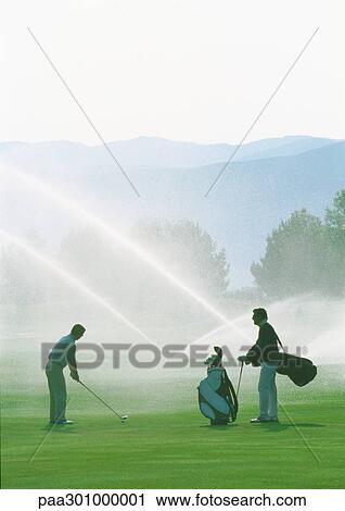 Golfers golfing among sprinklers View Large Photo Image Stock Image - Golfers golfing among sprinklers. Fotosearch