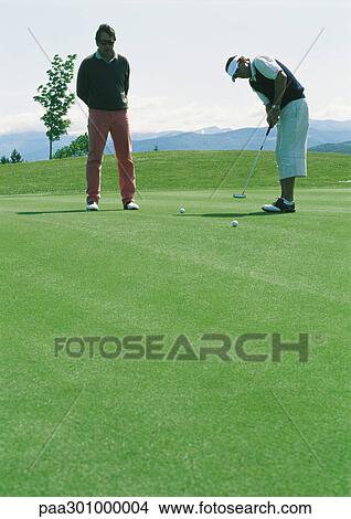 Golfers putting View Large Photo Image Picture - Golfers putting. Fotosearch