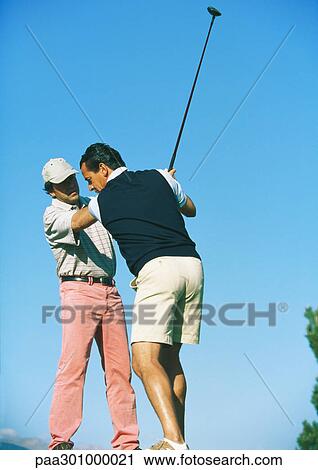 Man taking lessons with golf instructor View Large Photo Image Stock Image - Man taking lessons with golf instructor. Fotosearch