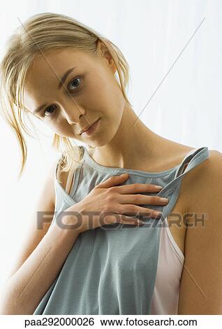 Young woman holding up tank top View Large Photo Image Stock Photograph - Young woman holding up tank top. Fotosearch