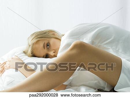 Young woman in bed, bending forward View Large Photo Image Stock Photo - Young woman in bed, bending forward. Fotosearch