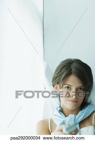 Young woman pointing remote control View Large Photo Image Picture - Young woman pointing remote control. Fotosearch