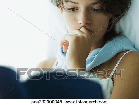 Young woman reading book, close-up View Large Photo Image Stock Photo - Young woman reading book, close-up. Fotosearch