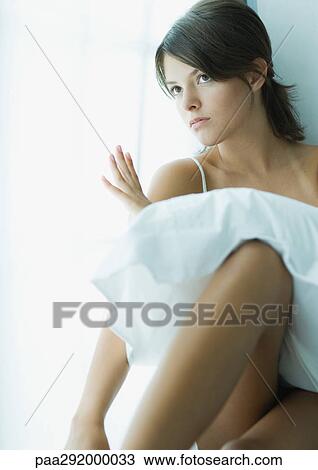 Young woman sitting with pillow on lap View Large Photo Image Stock Image - Young woman sitting with pillow on lap. Fotosearch