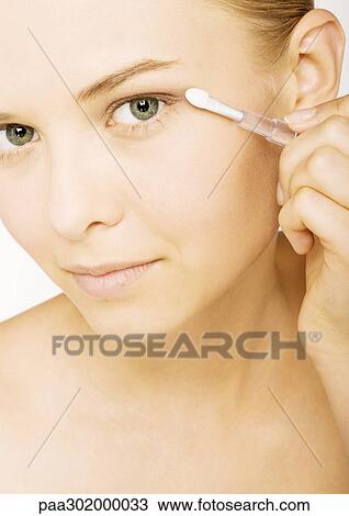 Woman applying eyeshadow View Large Photo Image Stock Image - Woman applying eyeshadow. Fotosearch