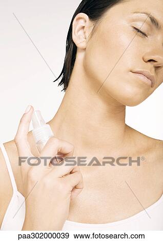 Stock Photo - Woman applying perfume. Fotosearch