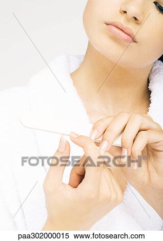 Woman filing nails View Large Photo Image Stock Photography - Woman filing nails. Fotosearch