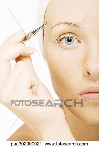 Woman tweezing eyebrow View Large Photo Image Stock Image - Woman tweezing eyebrow. Fotosearch