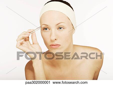 Woman tweezing eyebrows View Large Photo Image Stock Image - Woman tweezing eyebrows. Fotosearch