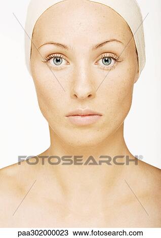 Stock Image - Woman wearing head band, portrait. Fotosearch