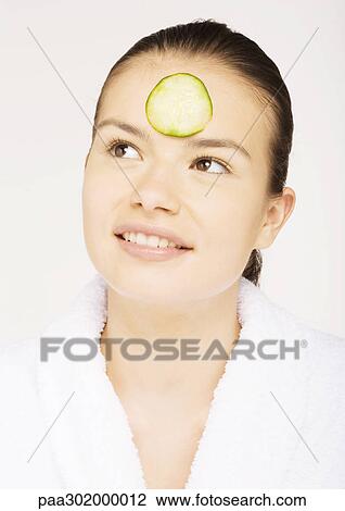 Woman with cucumber slice on forehead View Large Photo Image Stock Image - Woman with cucumber slice on forehead. Fotosearch