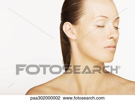 Stock Image - Woman with eyes closed and bare shoulders. Fotosearch